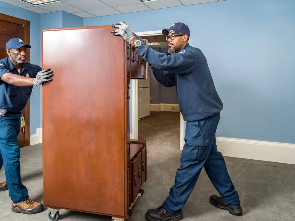 AOC employees moving furniture in a Senate office building.